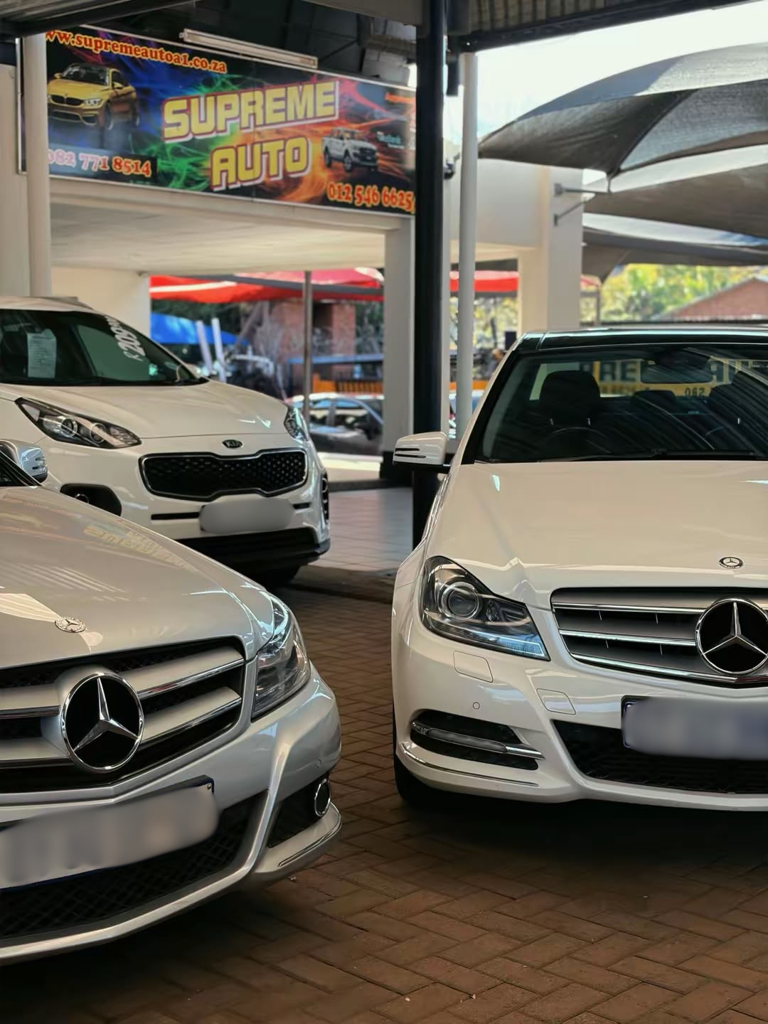 Two matching Mercedes-Benz vehicles photographed on location at Supreme Auto's dealership